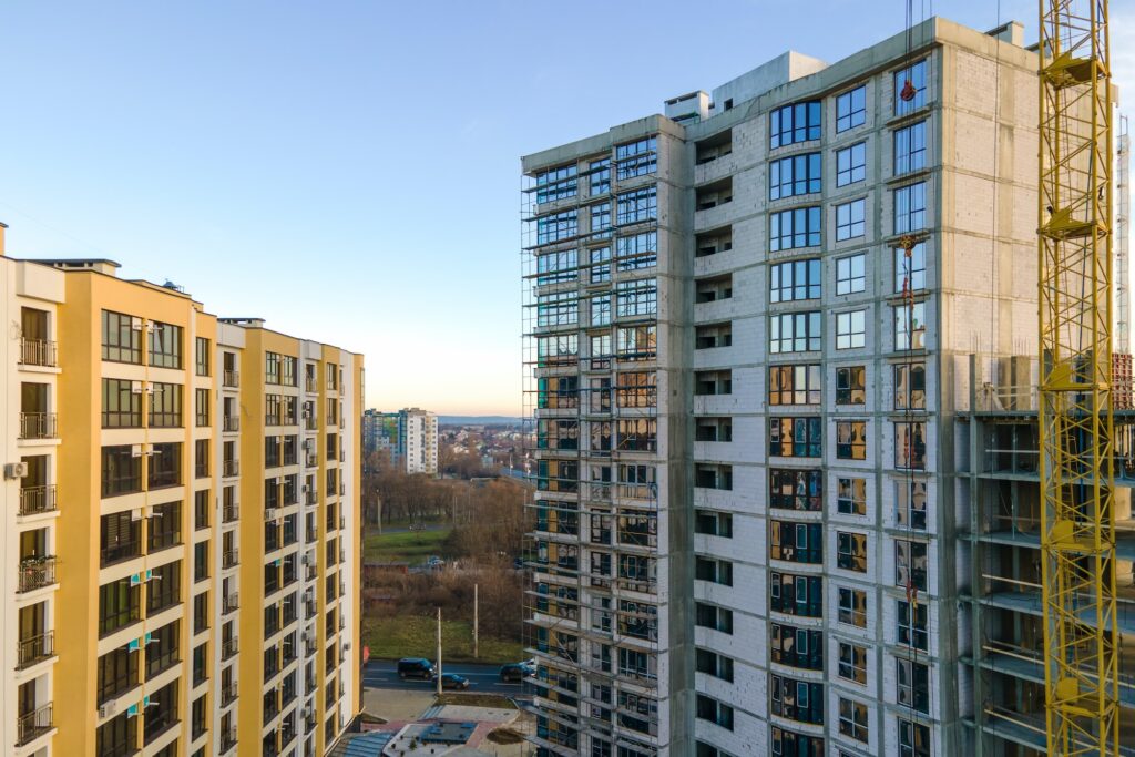 Aerial view of high residential apartment building under construction. Real estate development