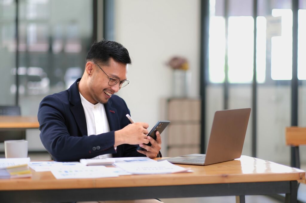 Portrait of a male business owner showing a happy smiling face as he has successfully invested his