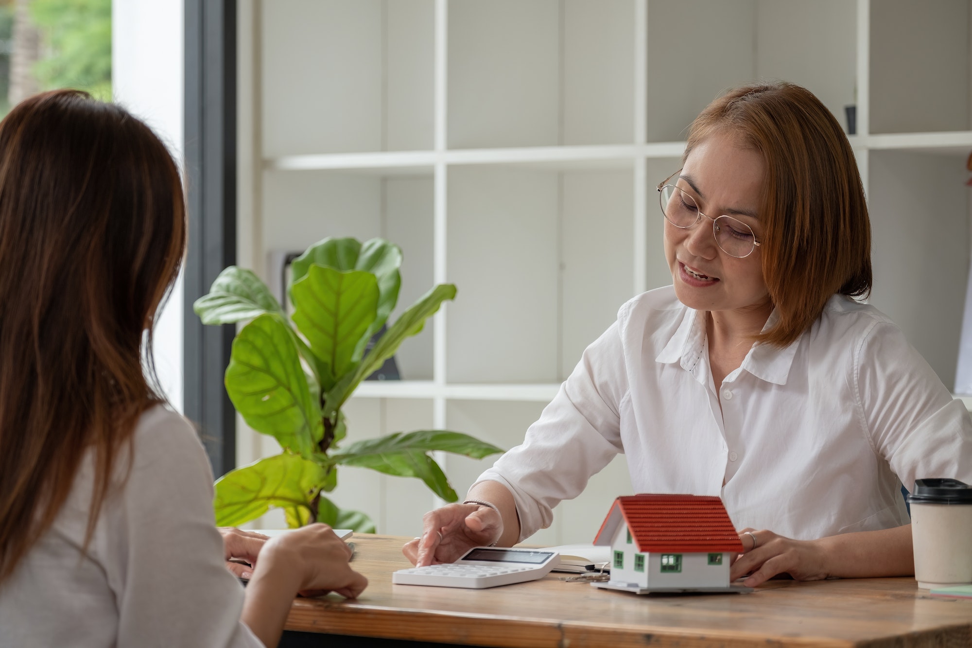 Real estate broker agent being analysis and making the decision a home estate loan to customer, She