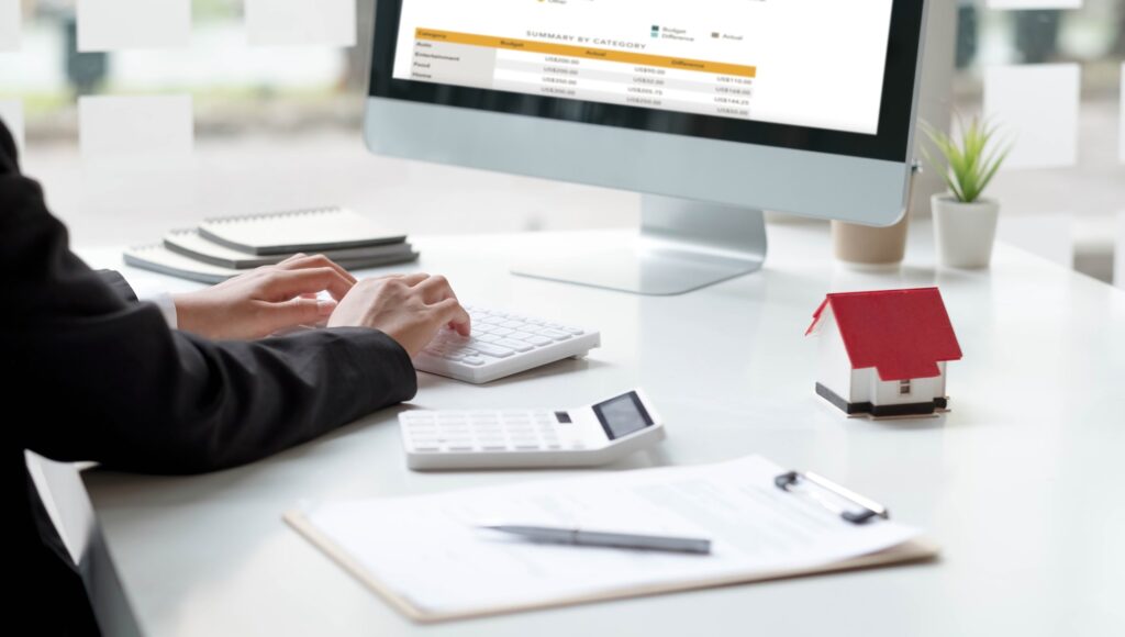Close up real estate business woman working with pc computer for financial accounting.